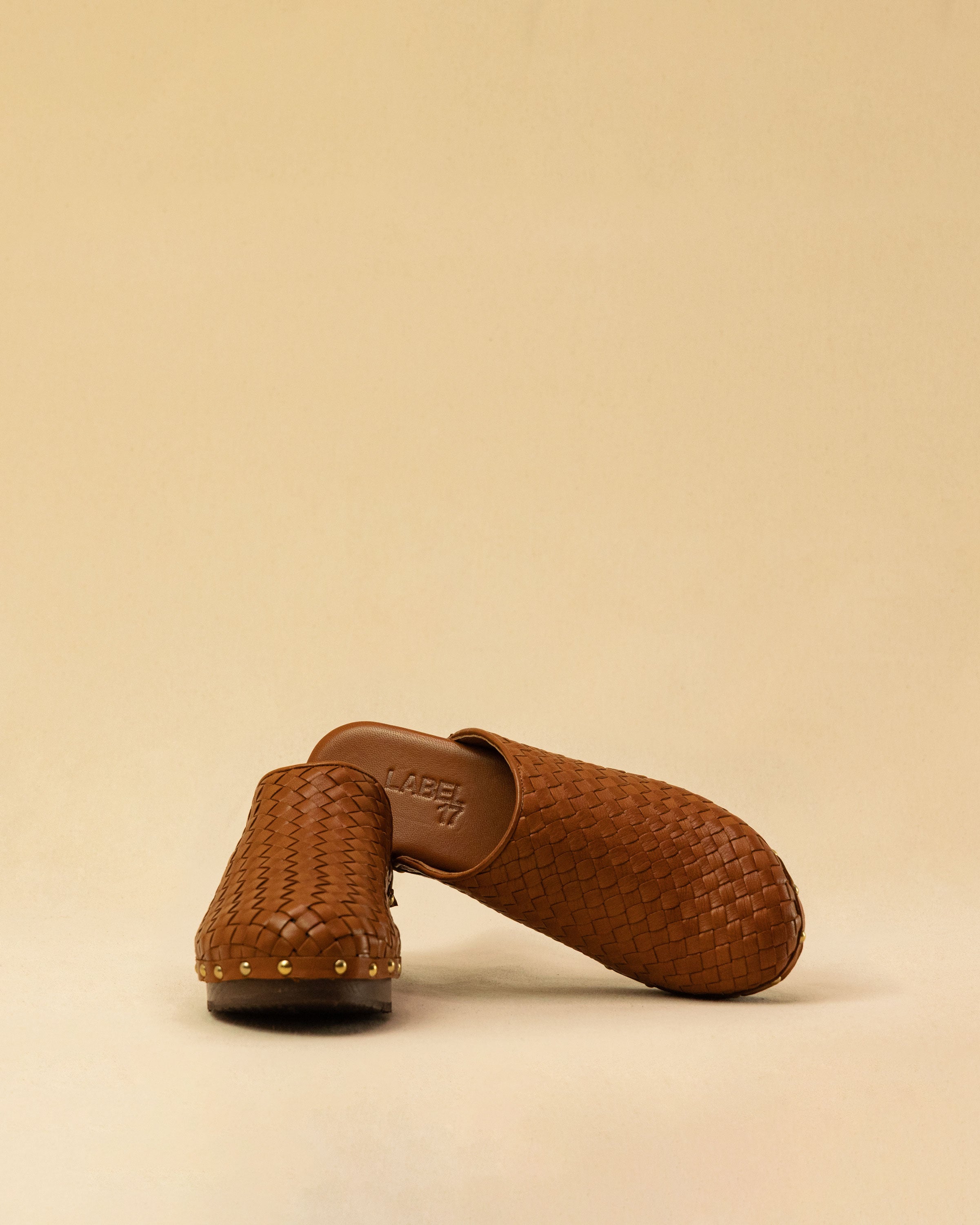 The Braided Clogs ATHENA by LABEL17 are expertly crafted from supple, vegetable-tanned leather, meticulously hand-braided for a rich, textured finish. The intricate craftsmanship showcases the beauty of traditional techniques, while a durable Vibram sole provides lasting comfort and stability with every step. Designed with an artisanal approach, these clogs make a refined yet effortless statement. Quiet luxury at its finest. Handmade in Greece.