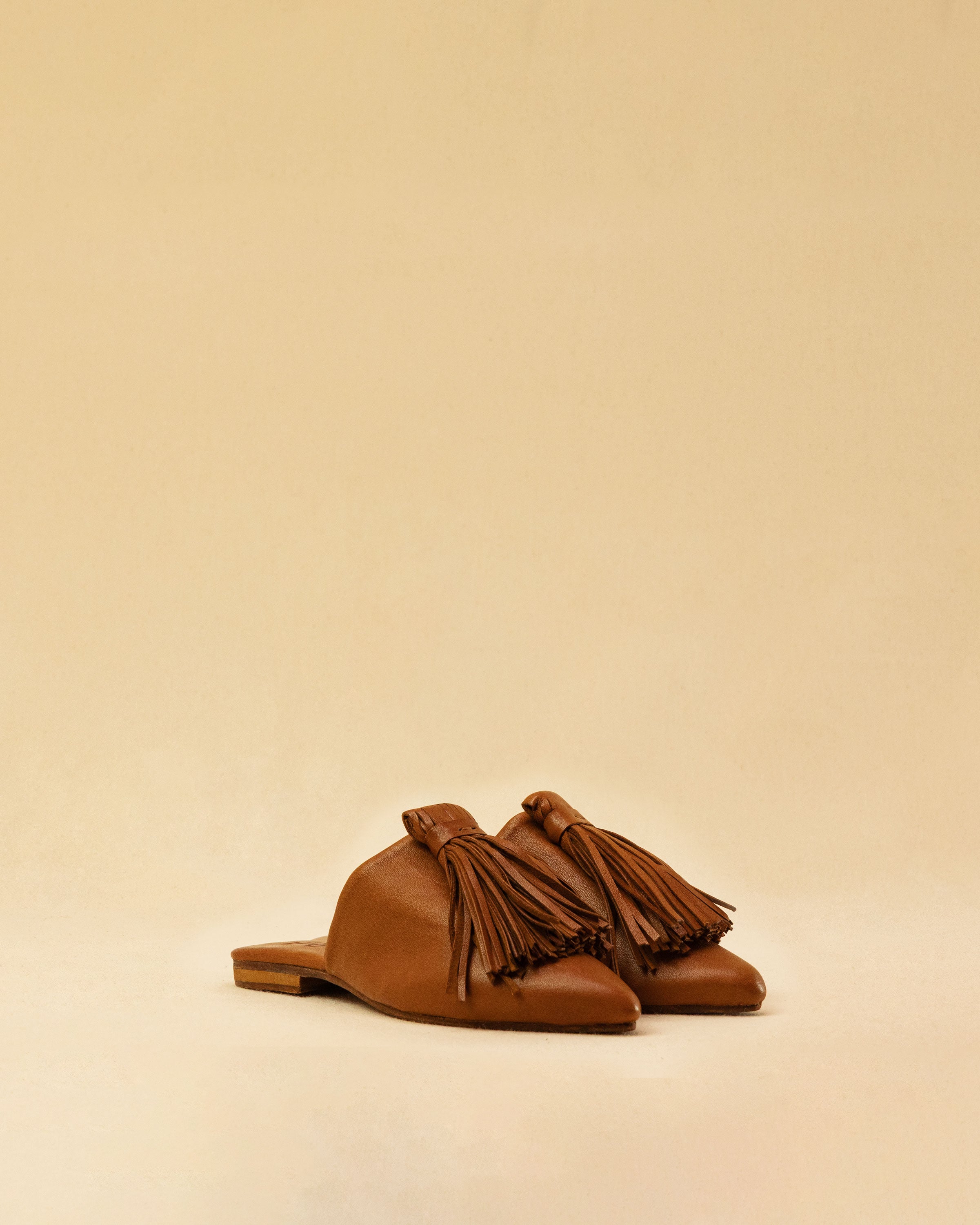 The Mule CHOUCHA by LABEL17 is crafted from supple, vegetable-tanned lamb nappa leather. A large, soft pompom sways elegantly with every step, adding a playful yet refined touch to the design. Handmade in Morocco.