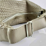 The LABEL17 Shoulder Bag Saddle Tresse is braided by hand and crafted from the most supple Nappa leather exemplifying luxury and durability. Designed with a unique saddle shape, it conforms seamlessly to your body. The bag is lined with leather and has practical compartments, including a zippered compartment for safe storage. Featuring a zipper and an adjustable shoulder strap, this versatile accessory offers the freedom to be worn over the shoulder or across the body.